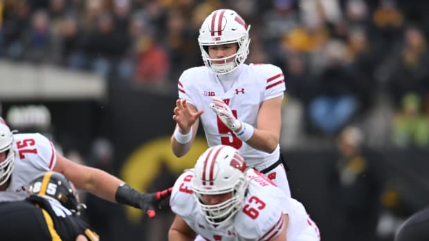 Wisconsin quarterback Graham Mertz receiving the snap out of shotgun at Iowa